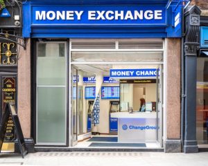Traditional currency exchange office — fast but high-risk compared to digital escrow
